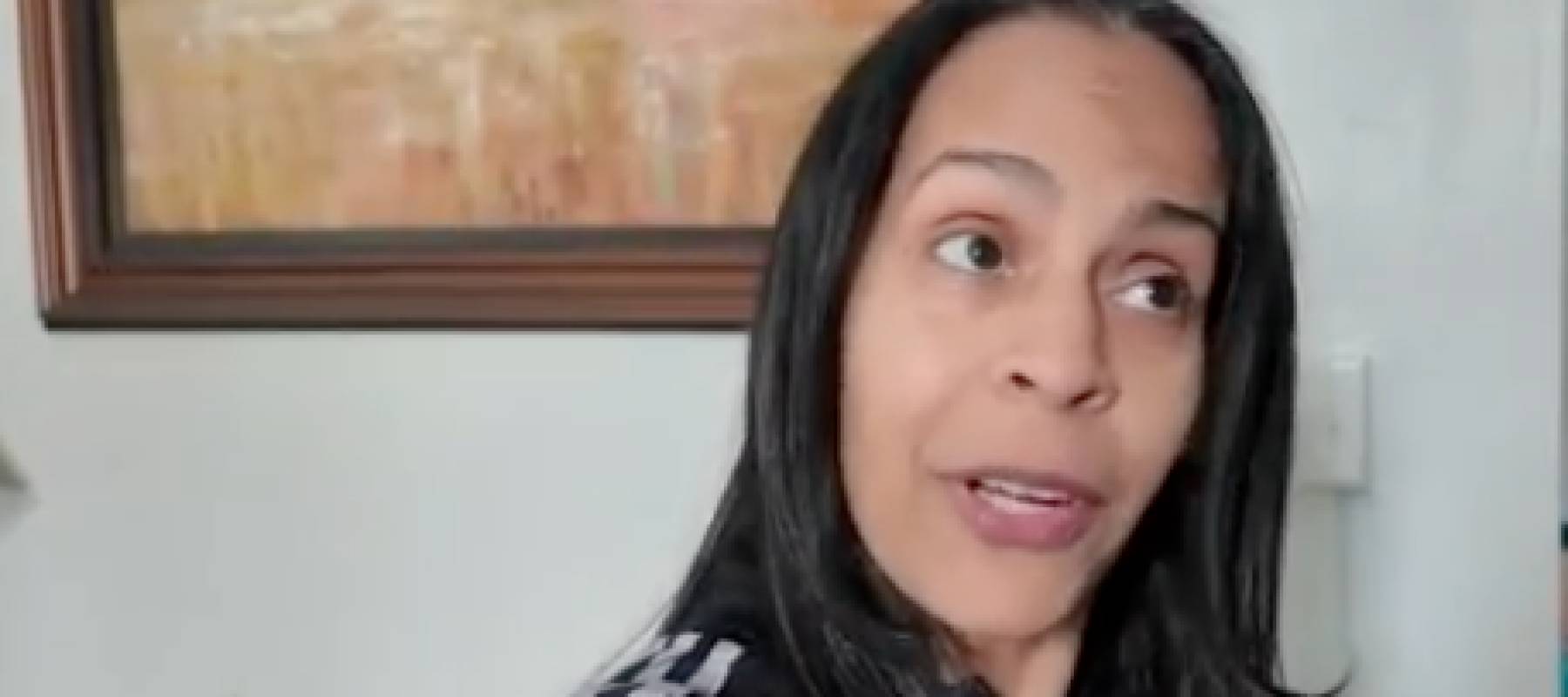 Woman in apartment talking.