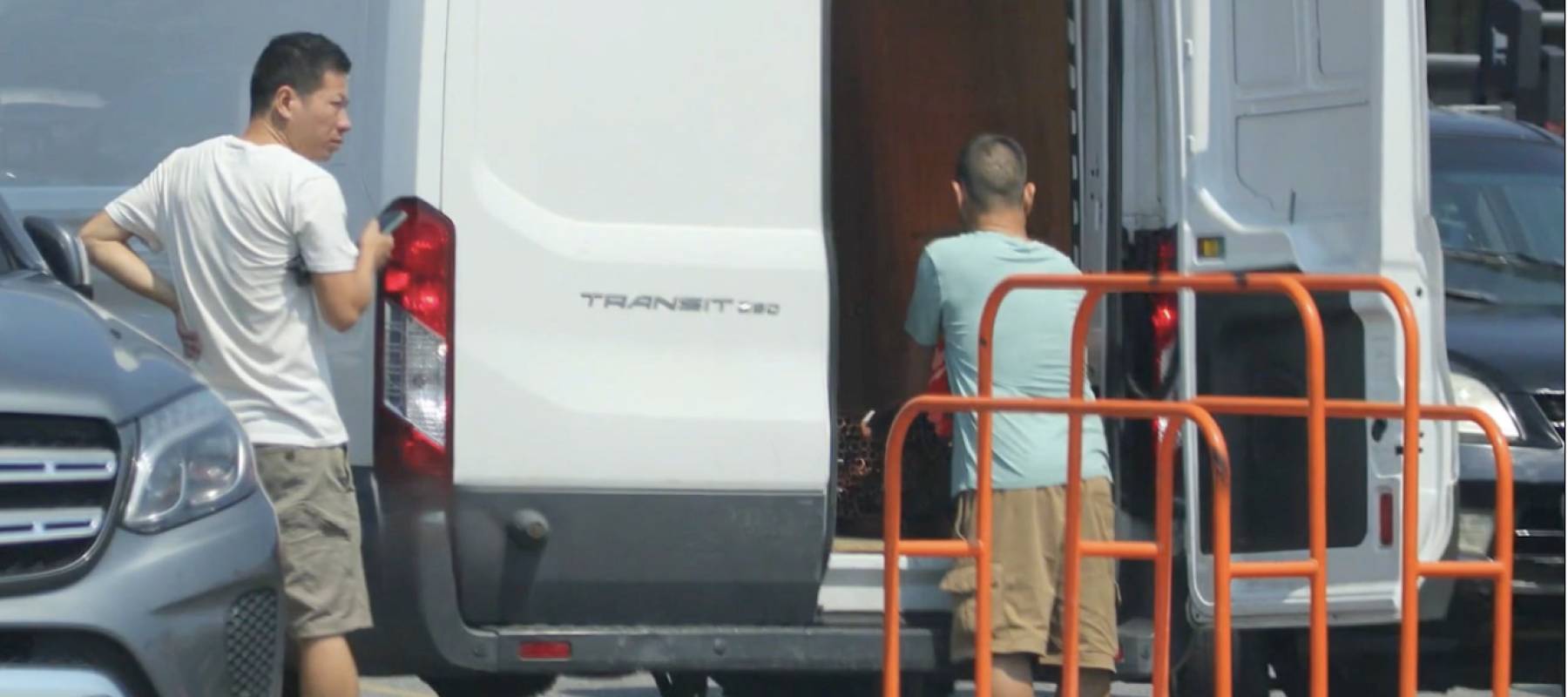 Two men seen loading items into the back of a truck in Home Depot parking lot.