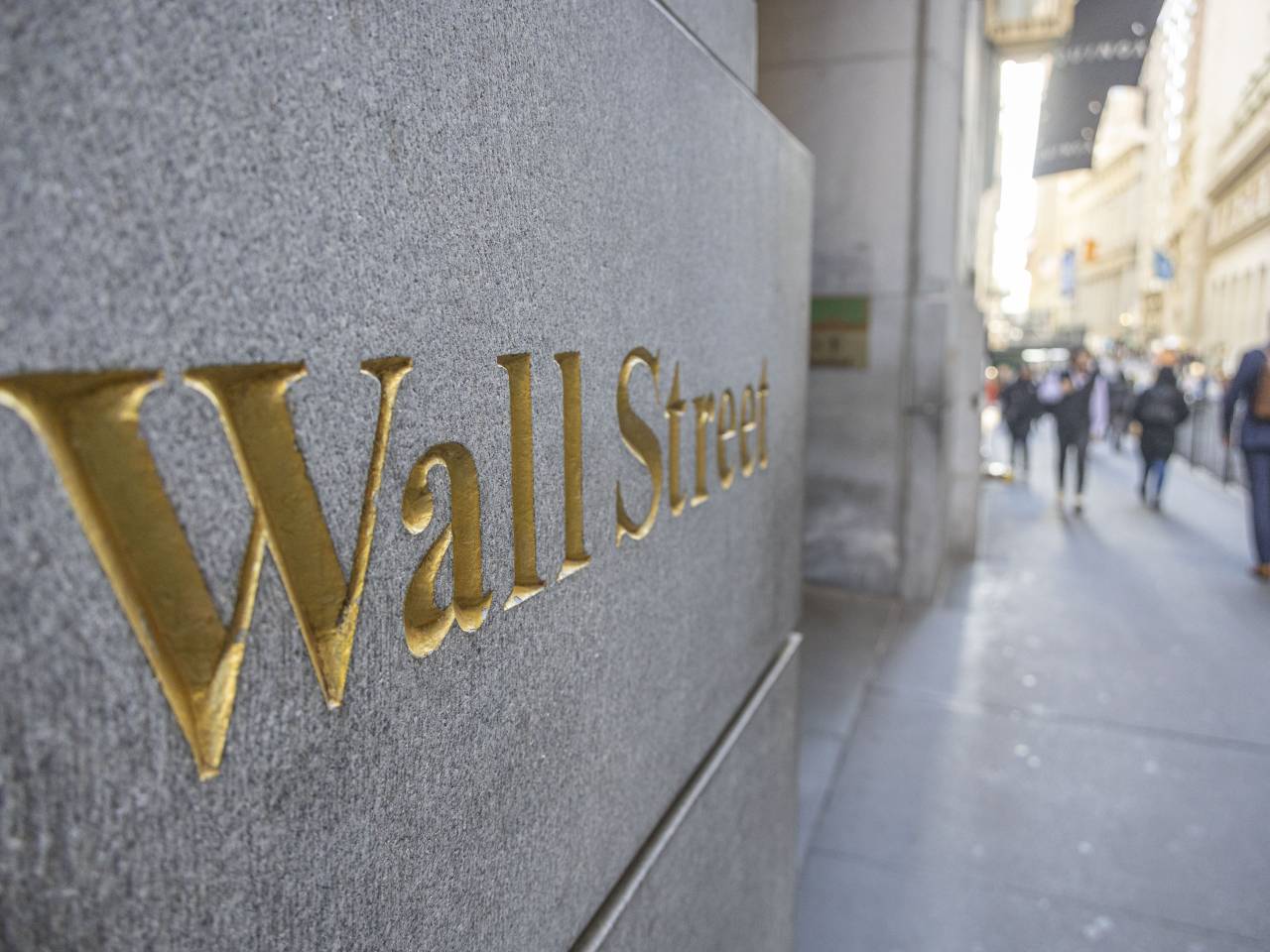 Wall Street sign on building.