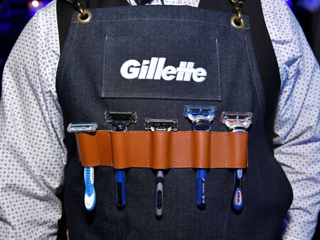 Man wearing apron featuring Gillette razors.