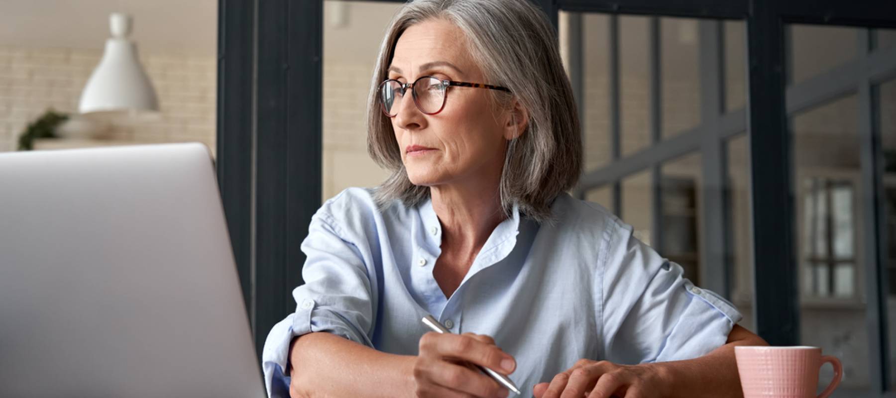Woman at keyboard studying.