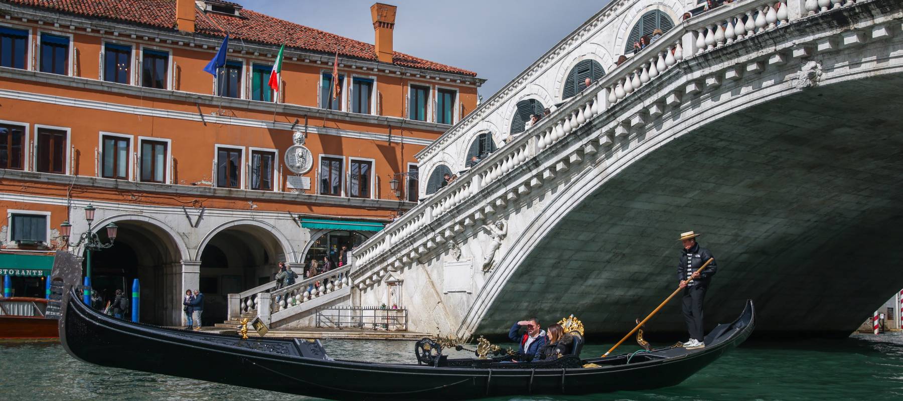 Two people riding in a Venice gondola.