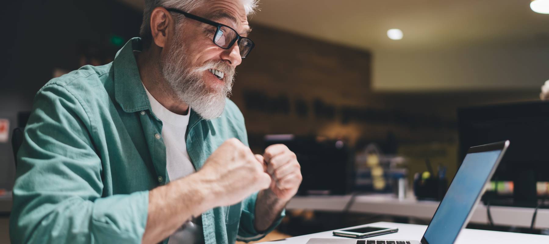 Excited man looking at his computer