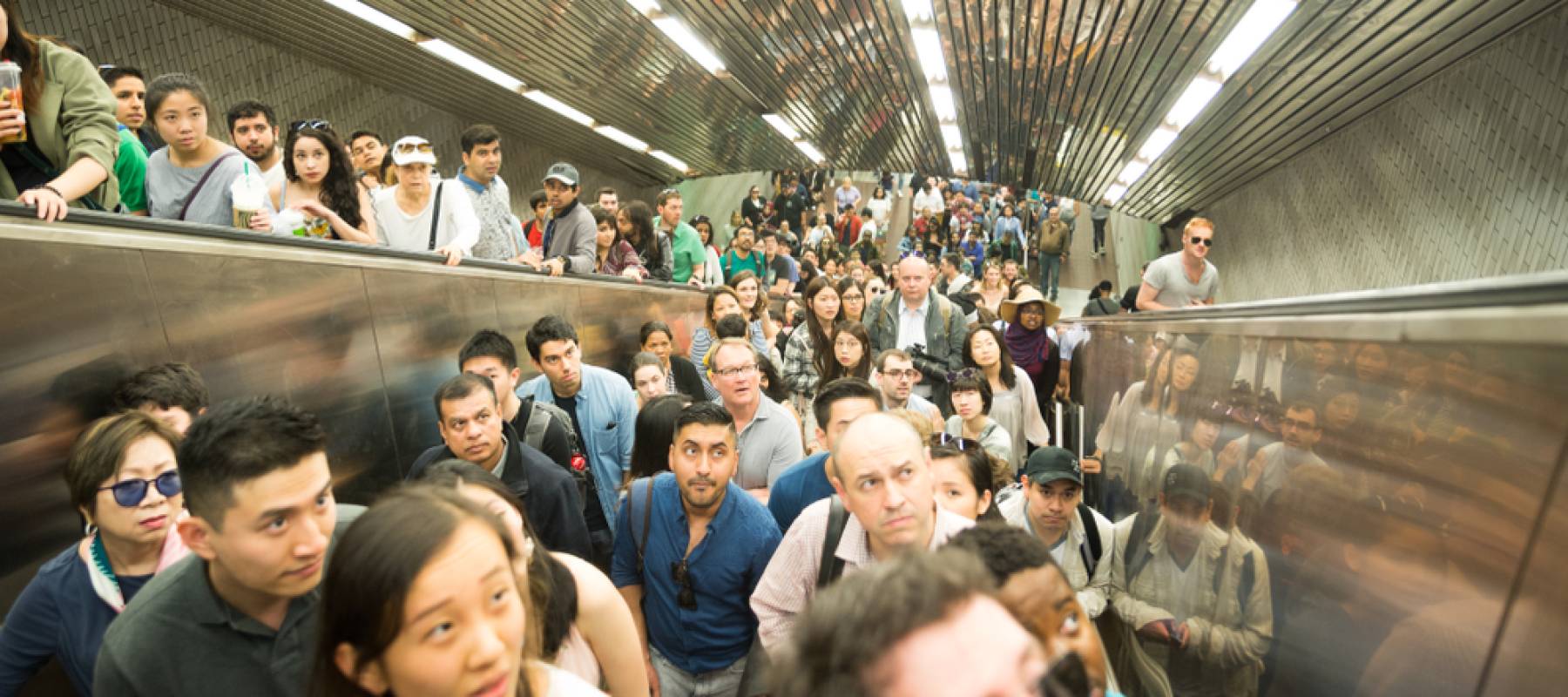 Crowds of people wait in a crowded subway in roosevelt island