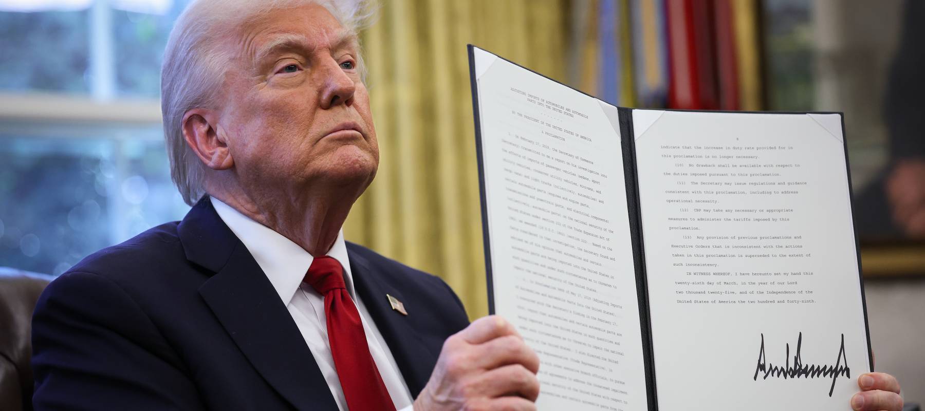 Trump showing off a newly-signed tariff.