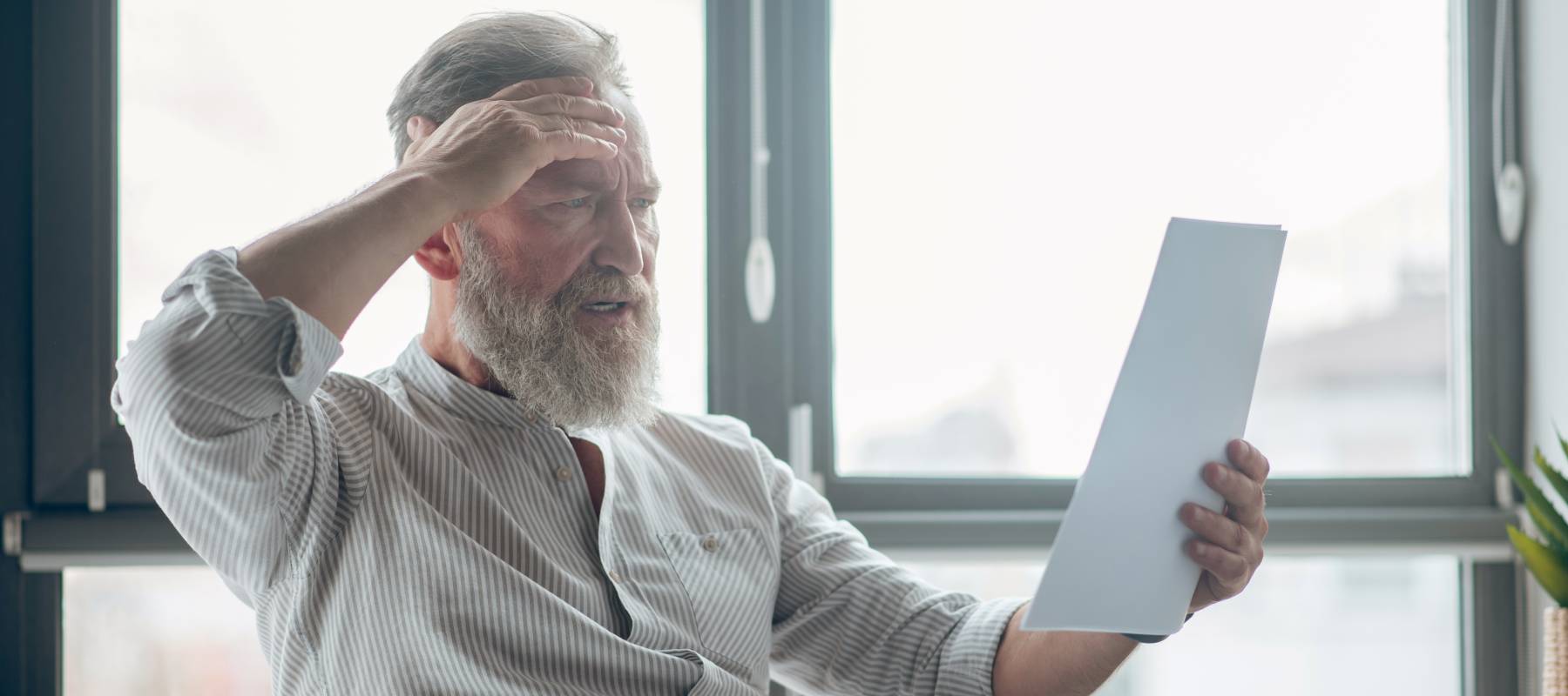 An older man confused by a letter.