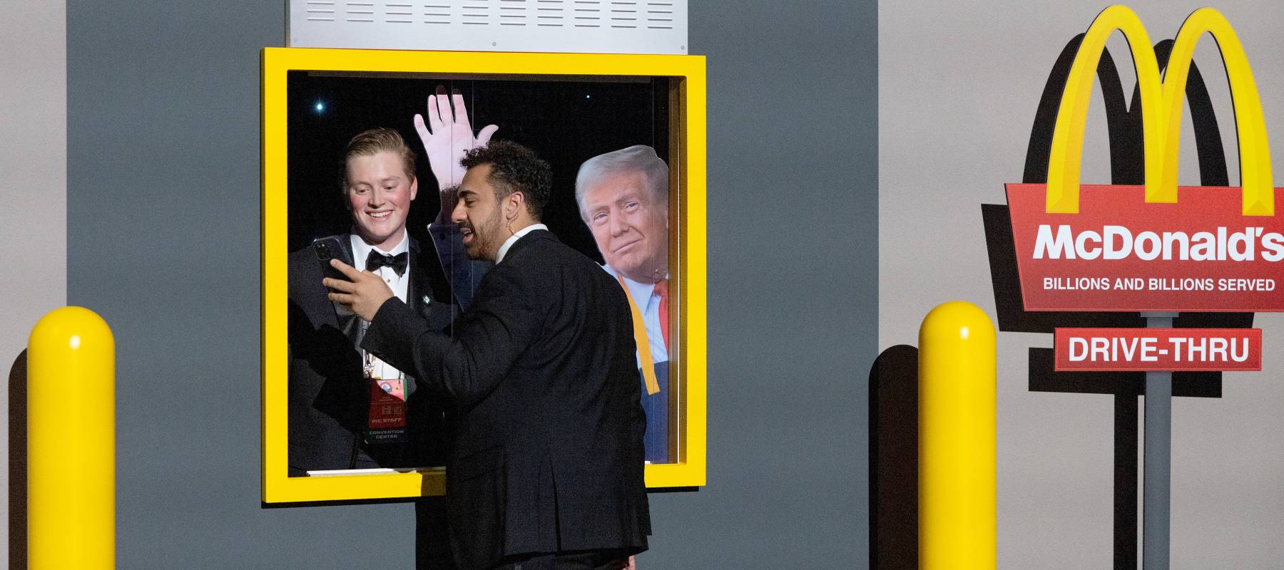 Customer posing with Trump cut-out in McDonald's drive-thru.