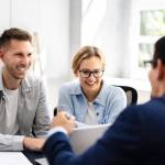 A young couple meeting with a financial advisor.