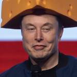 Elon Musk arrives for a town hall wearing a cheesehead hat at the KI Convention Center in Green Bay, Wisconsin, March 30, 2025.