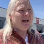 Man seen standing outside Tesla dealership, talking to the camera.