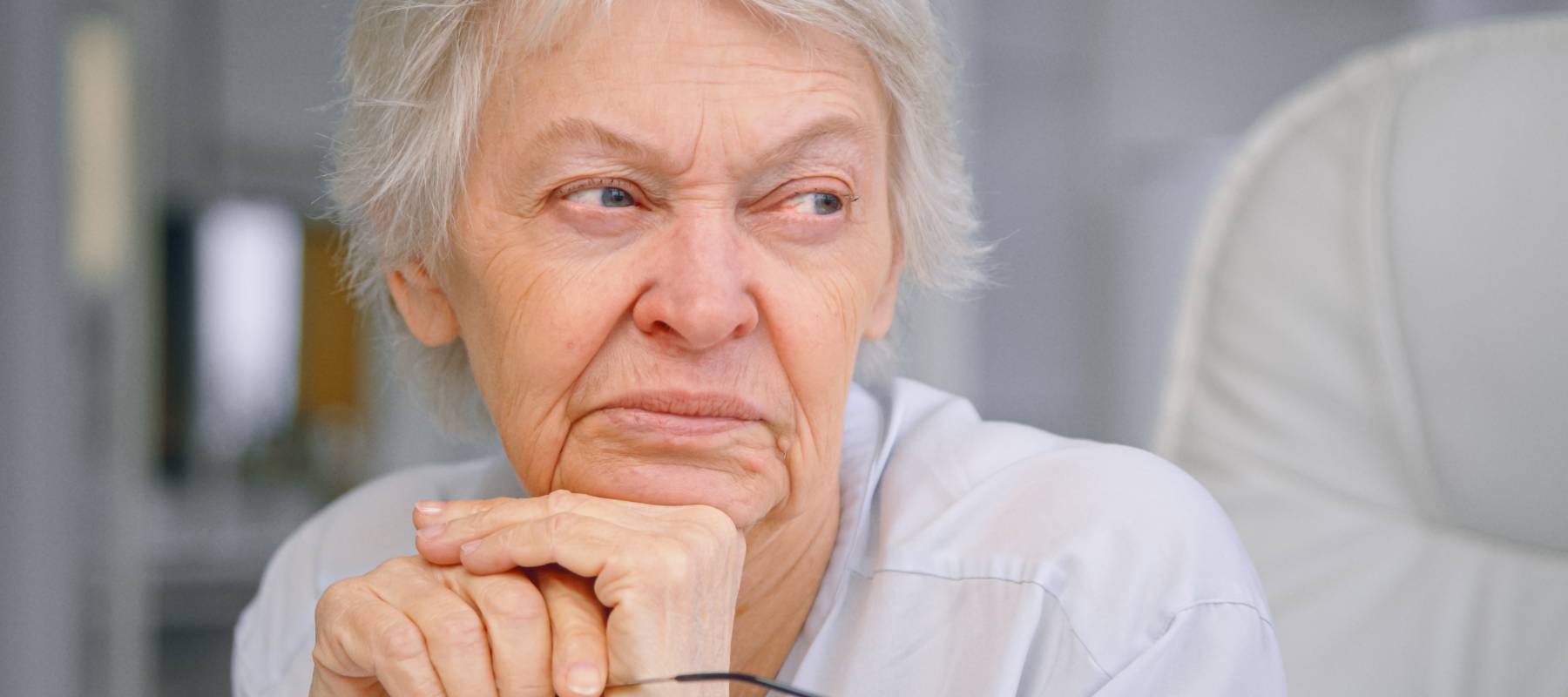 An older woman sits in thought.