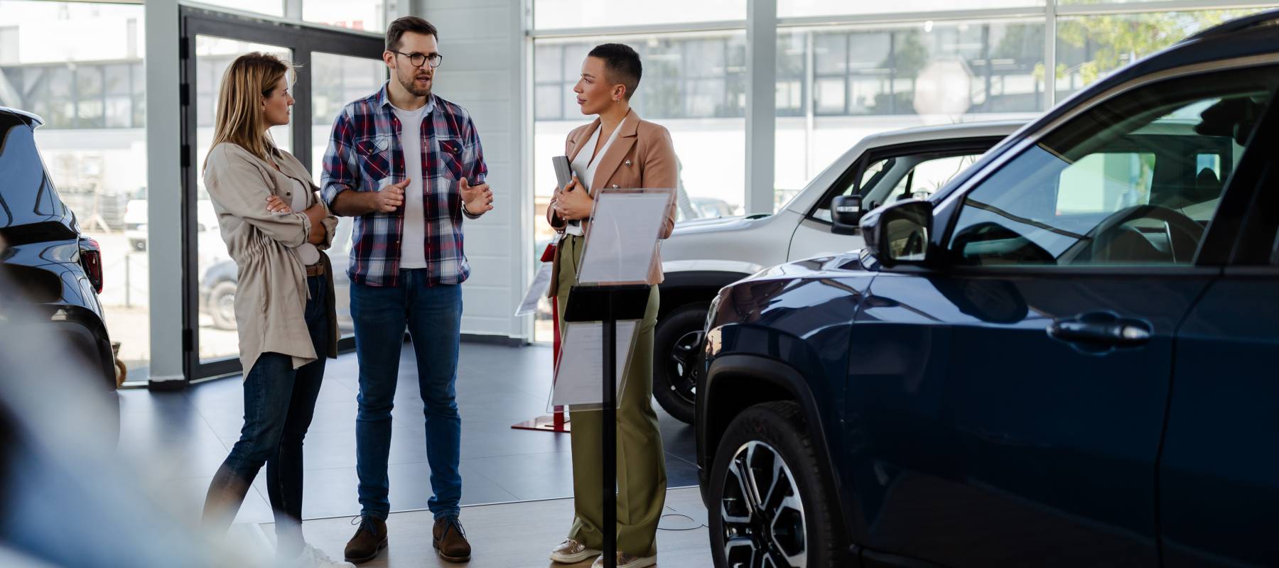 Man and woman shopping for a new car