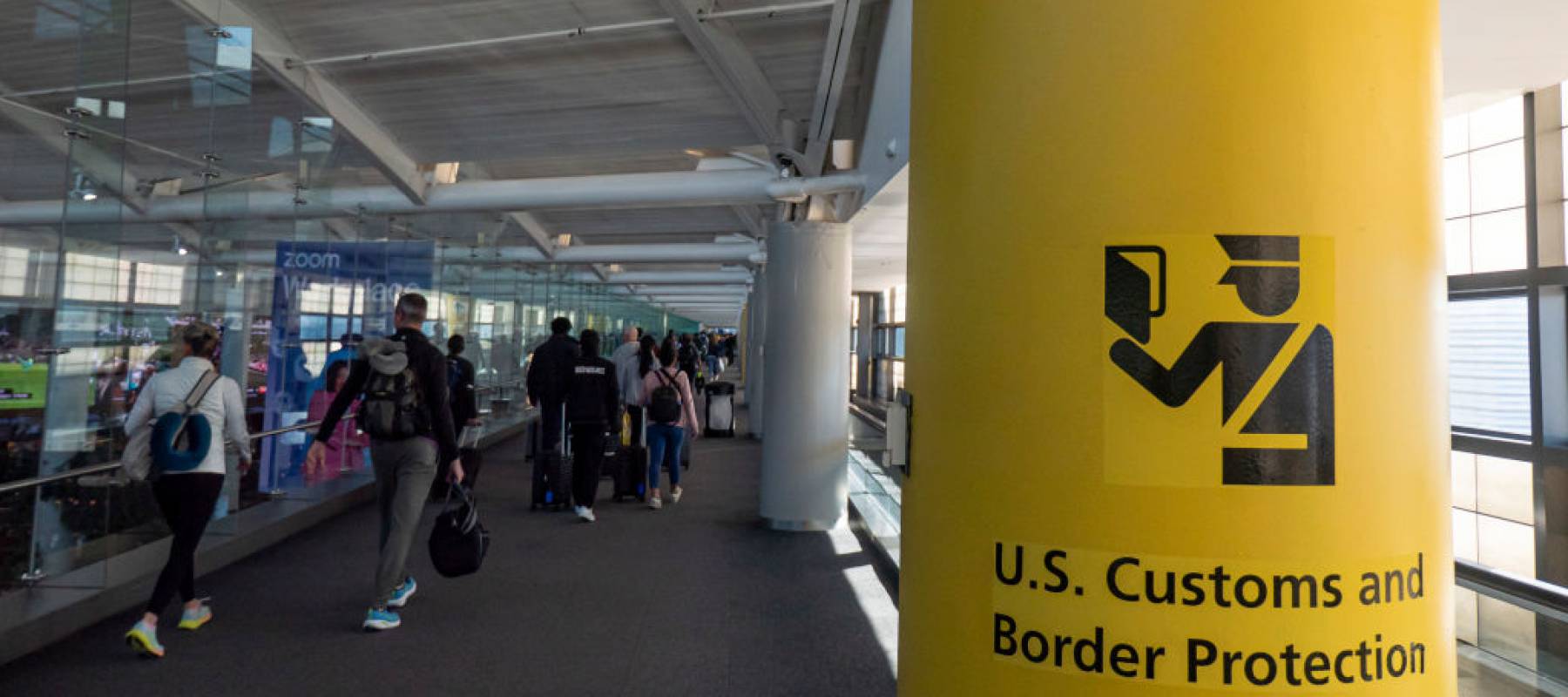 U.S. Customs and Border Protection CBP sign, inscription and symbol in yellow background in Newark Liberty International Airport.