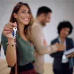 Woman holding up keys for new house