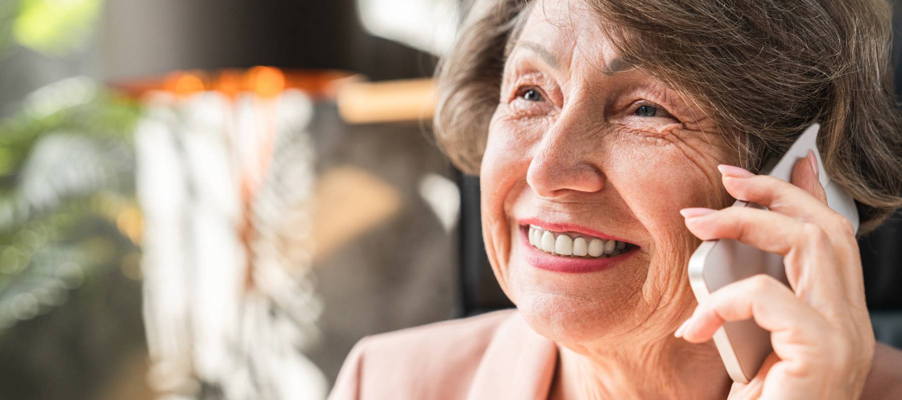 A cheerful older woman on the phone.
