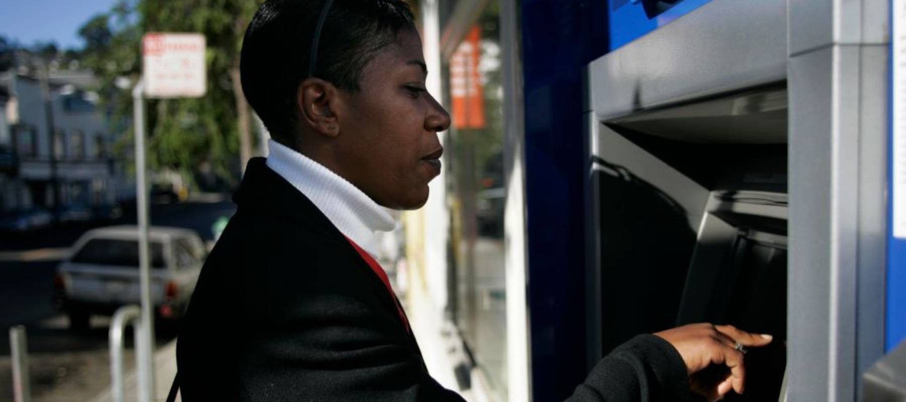 Woman using an ATM.