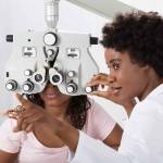 Female African Optometrist Doing Sight Testing For Patient In Hospital