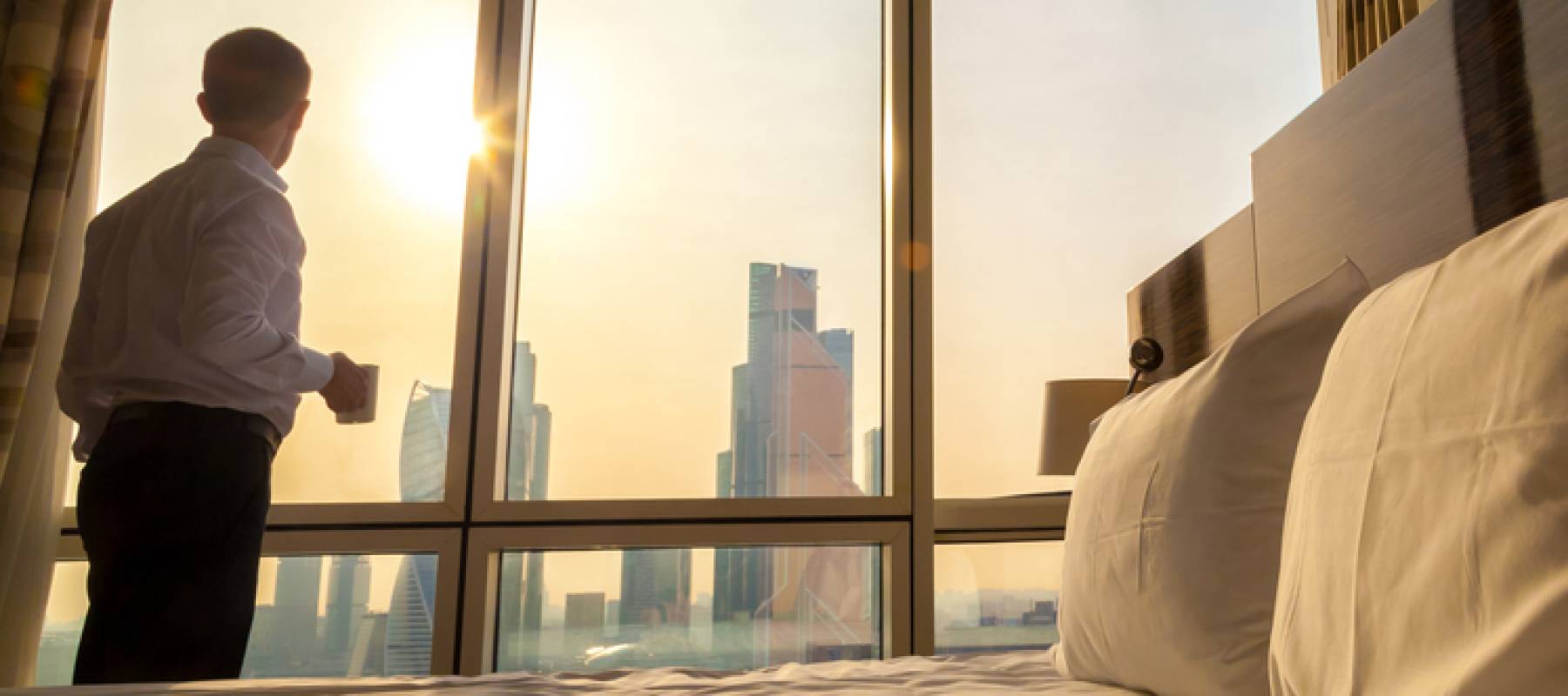 Man looking out window in. morning.