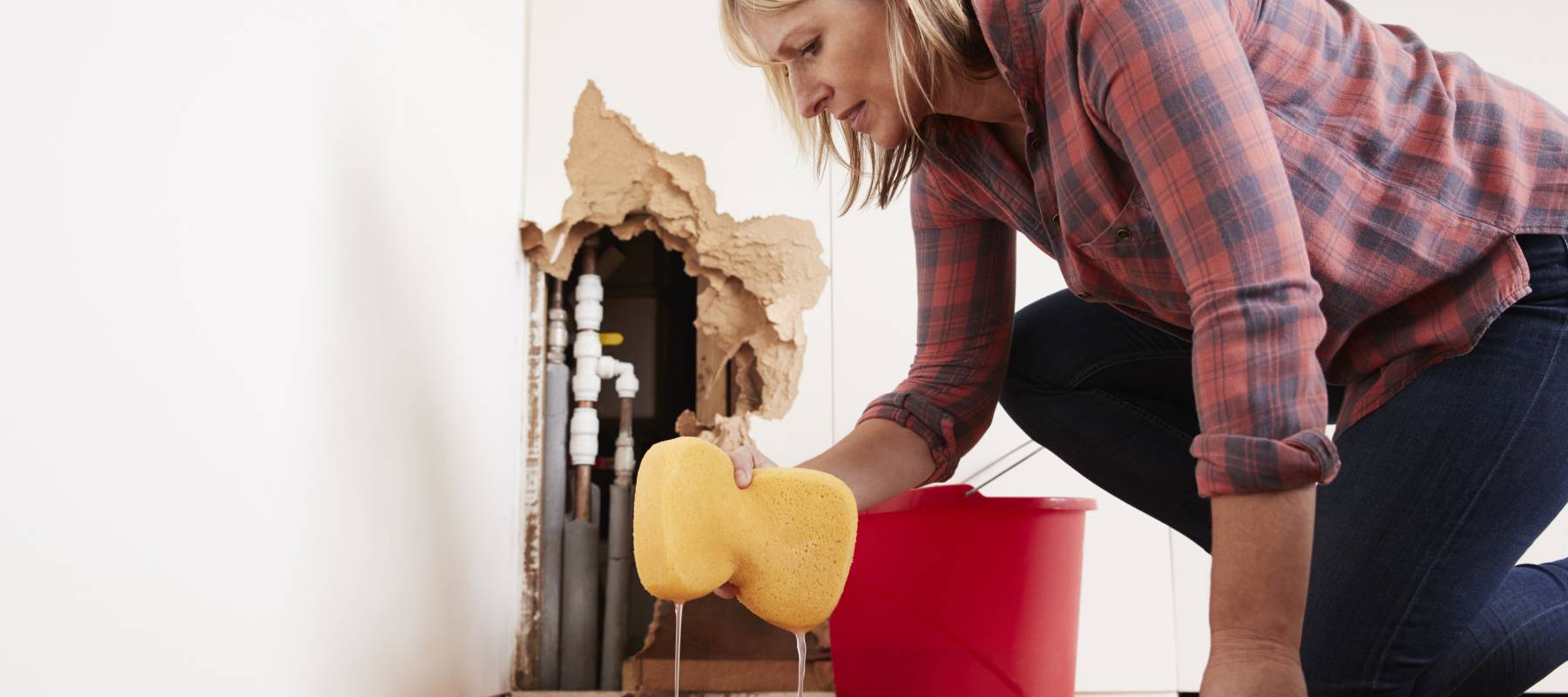 Woman cleaning up a flood in the basement