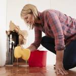 Woman cleaning up a flood in the basement