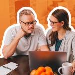 Couple discussing finances at computer