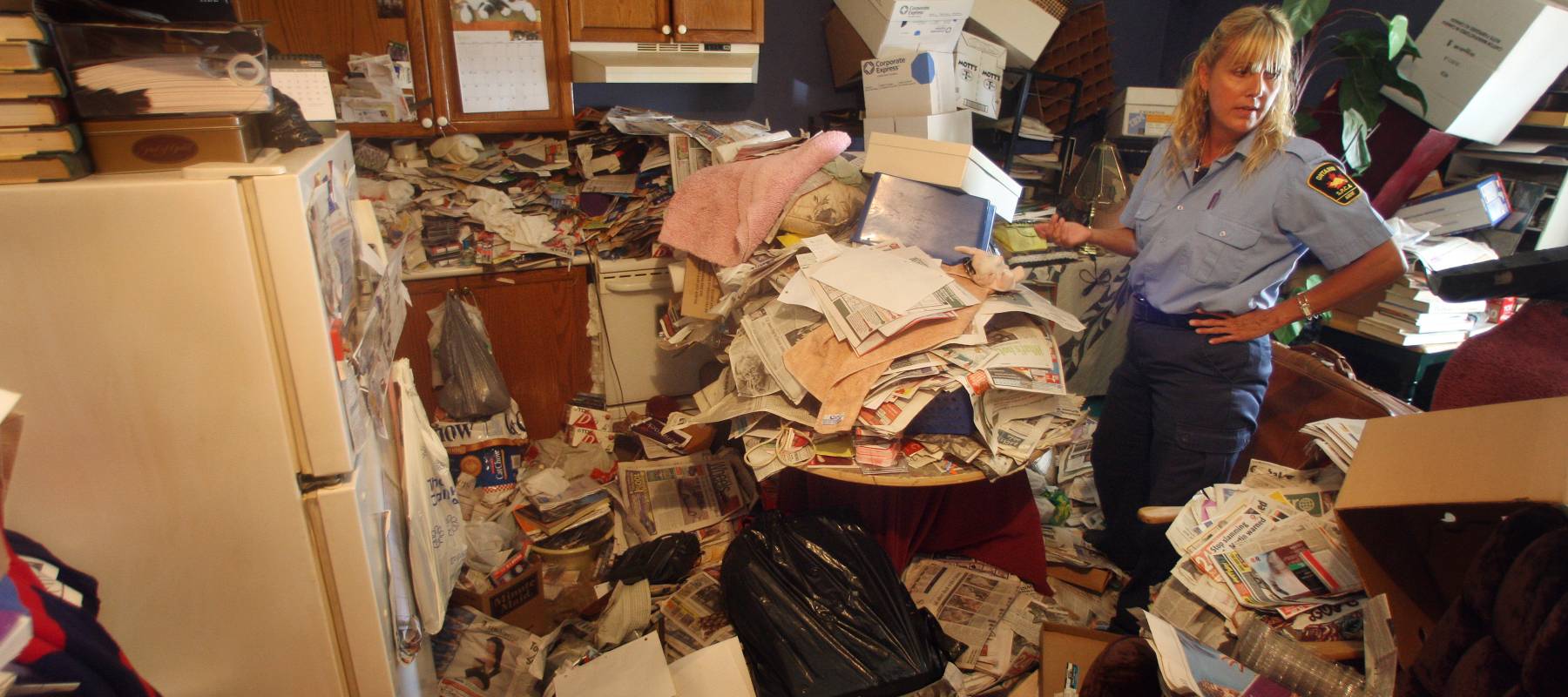 Officer in hoarder's residence.