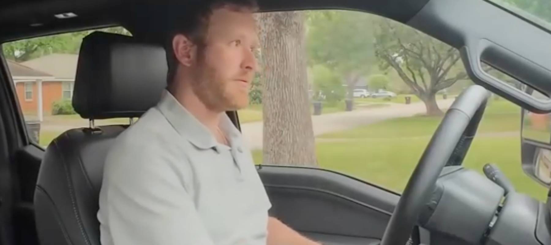 Man driving truck on a highway.