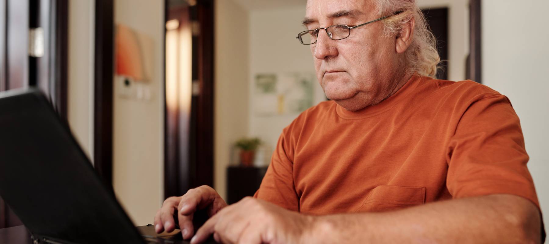 Man typing on his laptop.