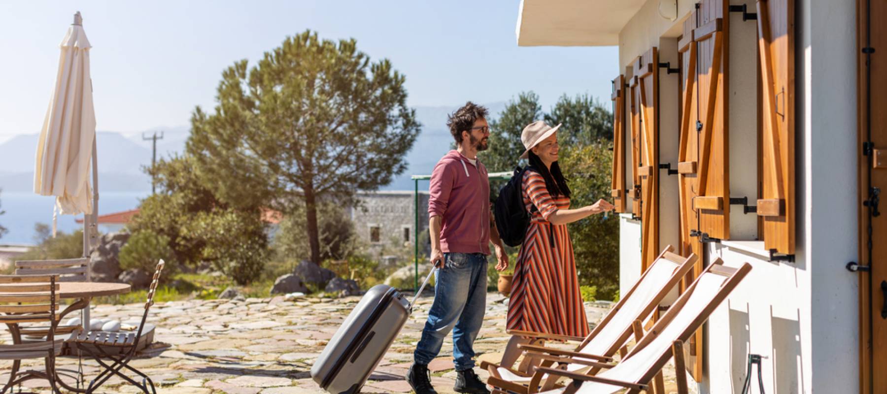 Young couple arriving at vacation home.