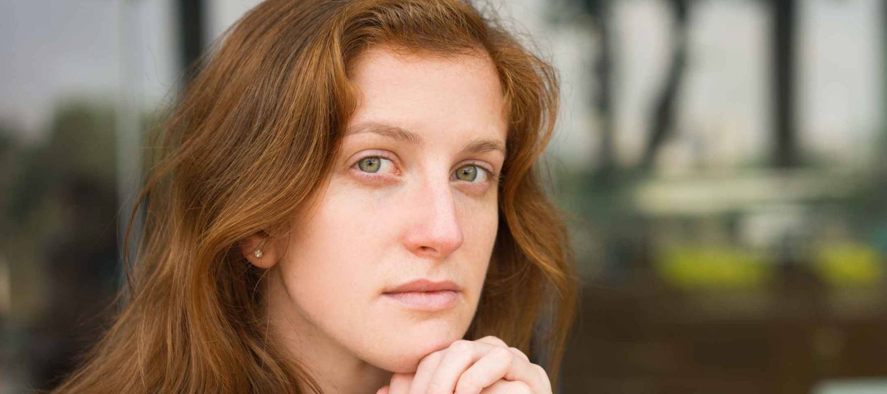 Closeup of Pensive Female Manager at Office Cafe