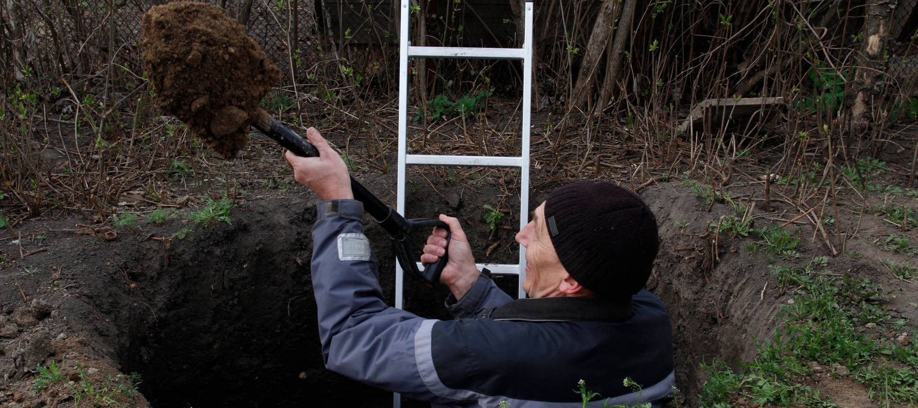 Man digging out a hole