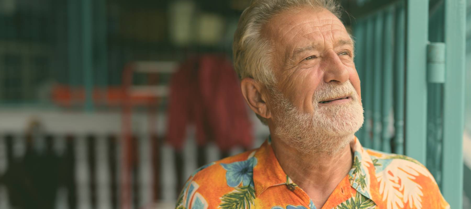 Man in a Hawaiian shirt looking out.