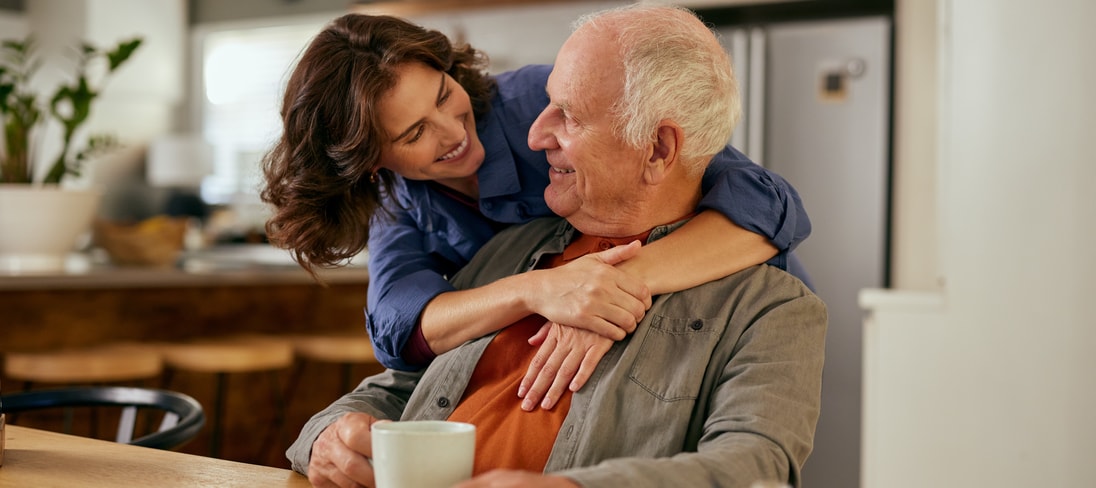 A father shares a moment with his adult daughter.
