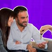 Woman Handing Over the House Keys to young couple.