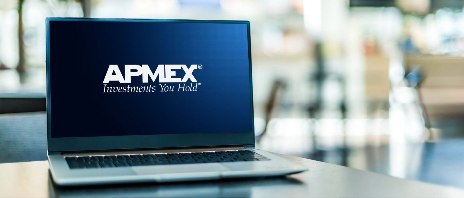 APMEX logo on a laptop screen