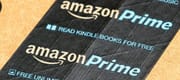 Amazon Prime logotype printed on cardboard box security scotch tape.