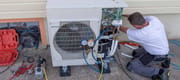 plumber at work installing a circulation heat pump