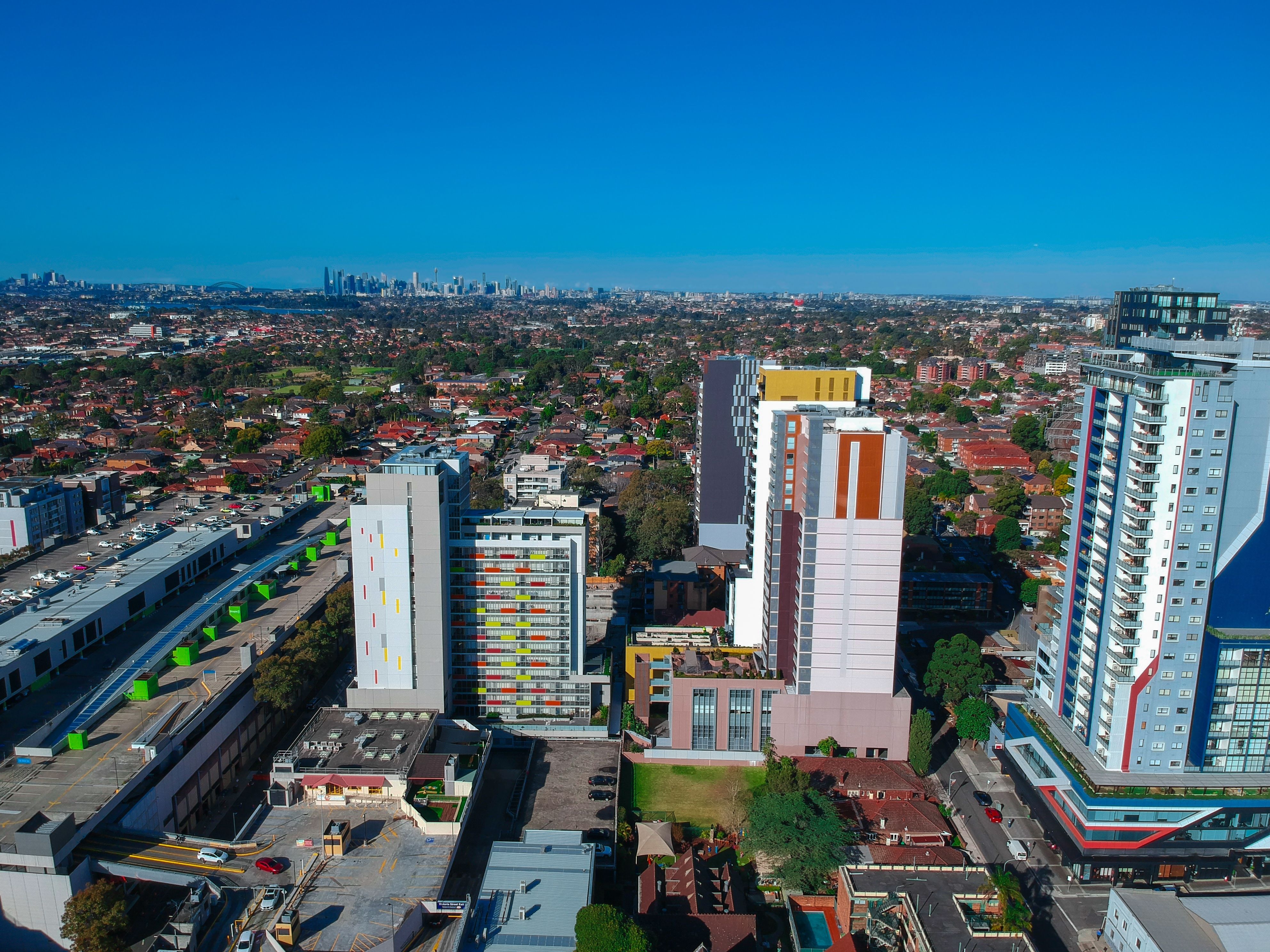 Drone view looking down on Commercial Suburb of Burwood in Sydney residential houses in suburbia suburban house roof tops and streets park NSW Australia