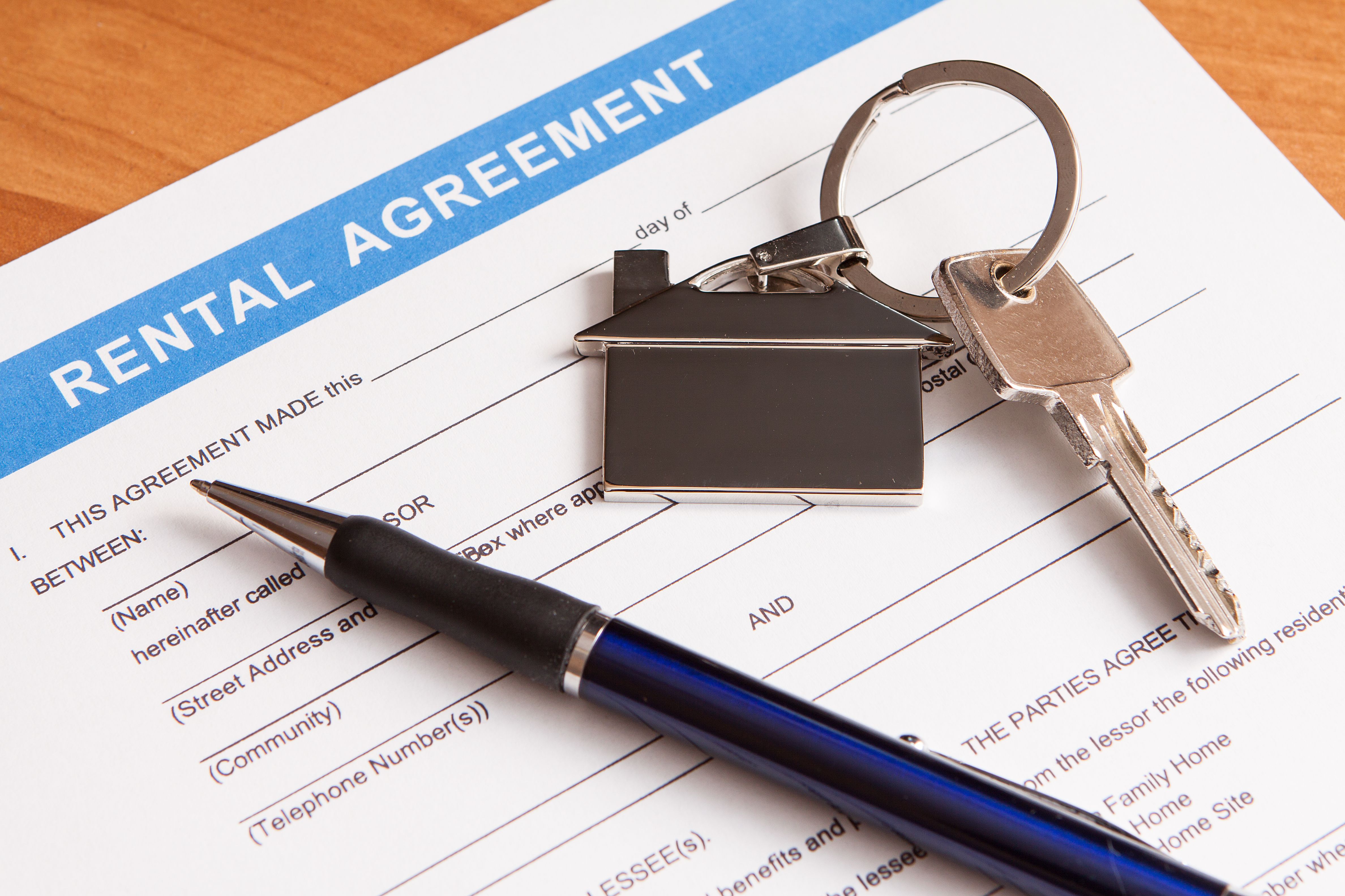 A pen, and keys on a rental agreement