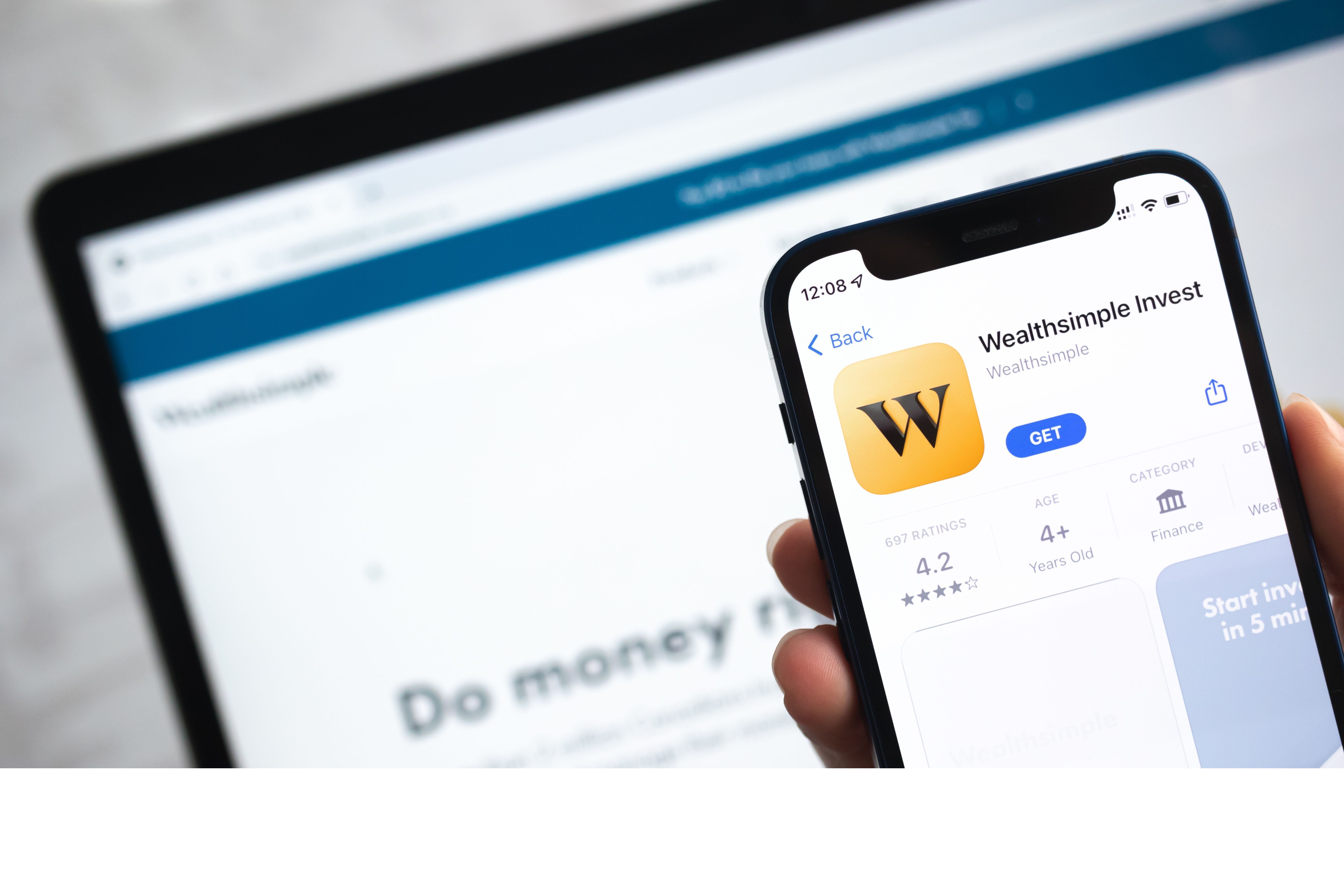 Poltava, Ukraine - April 5, 2022: Wealthsimple Invest app icon. Hand with mobile phone with application. Mobile banking and investment concept