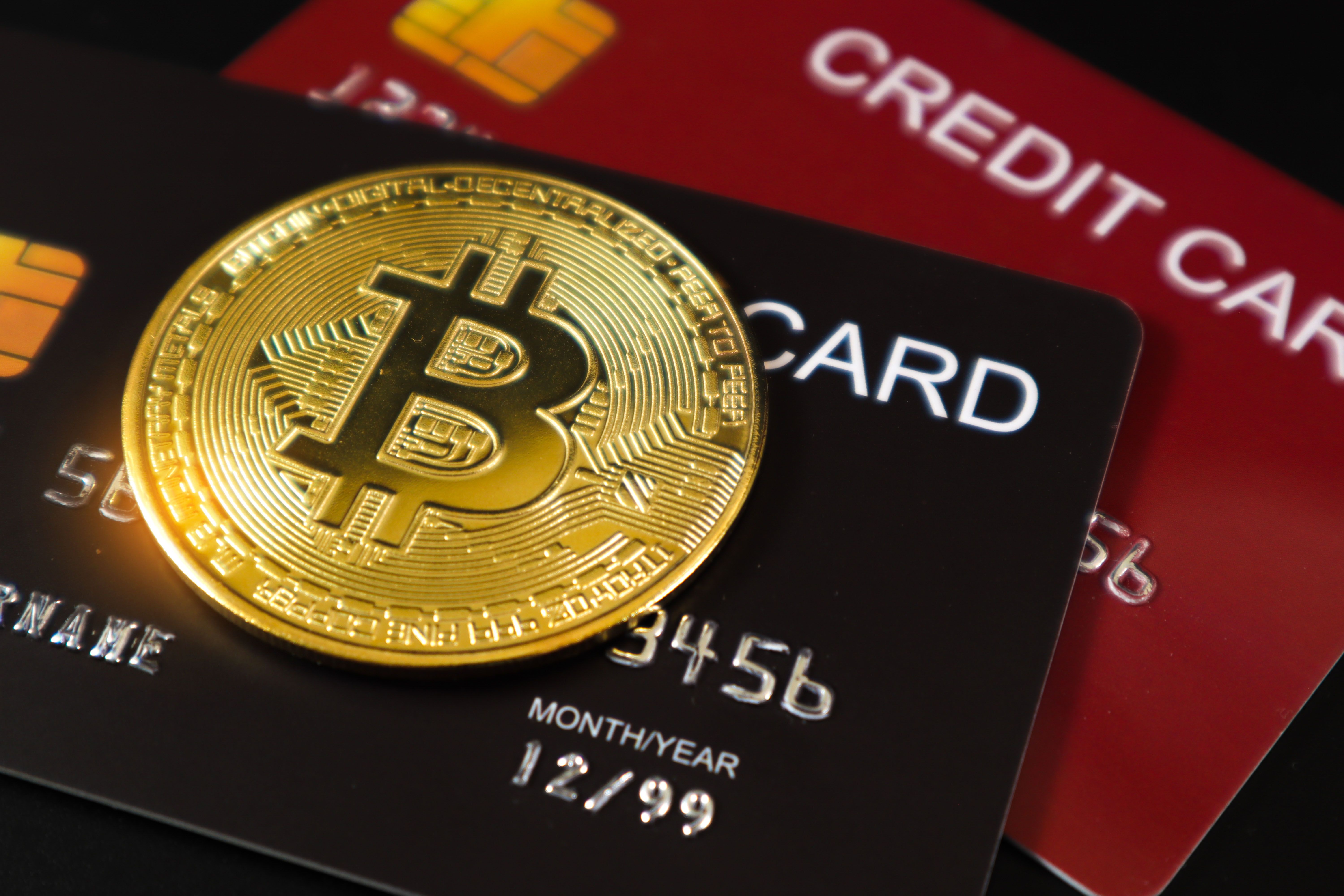 Golden bitcoin on credit cards. Business, money, cryptocurrency concept.