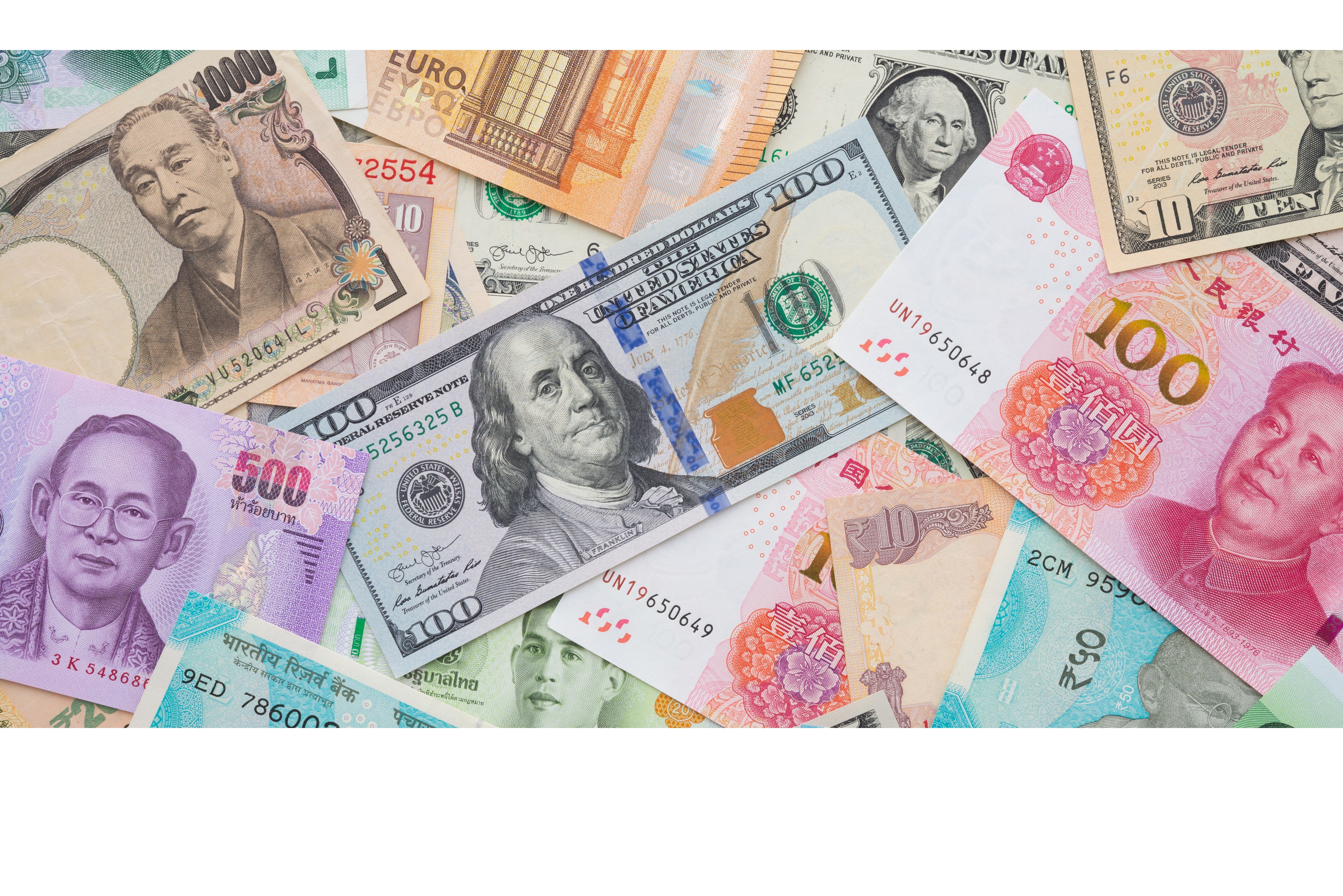Flat lay or top view of world international banknotes vary countries background. US Dollar, Chinese yuan, Japanese yen, Euro, Indian rupee, Thai baht. Concept of Forex or global financial economic.