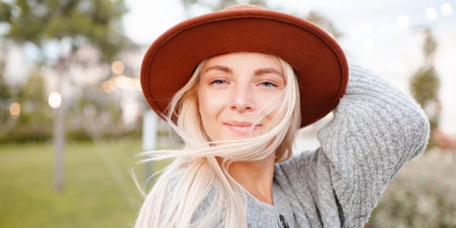 Blonde woman smiling in red hat