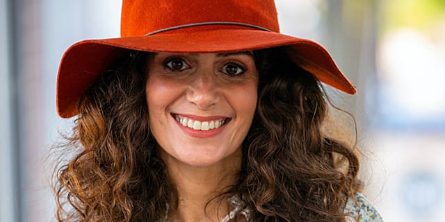 Woman in red hat smiling