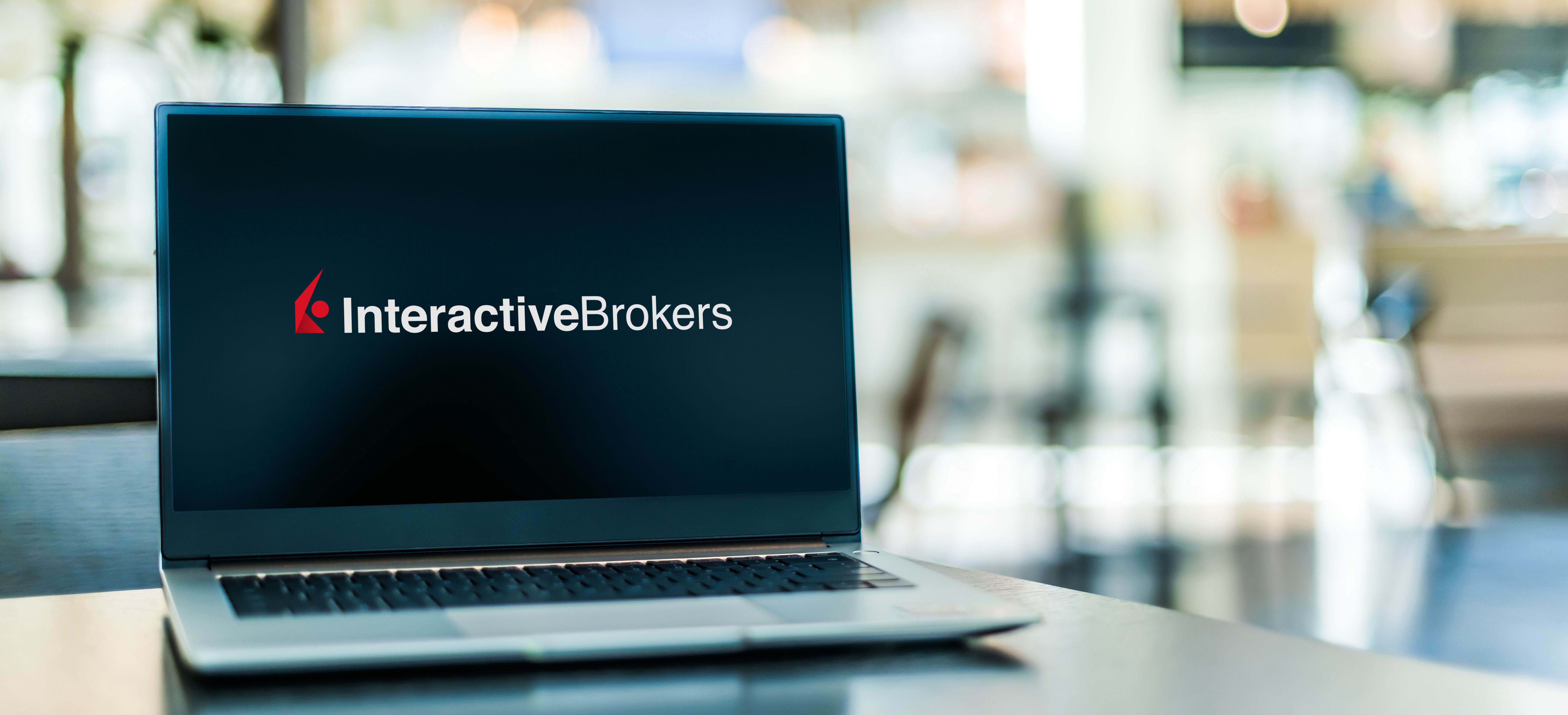Laptop computer displaying logo of Interactive Brokers LLC (IB), an American multinational brokerage firm