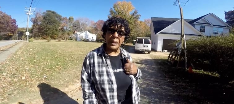 Anna Raleigh explaining the dispute over her property line.