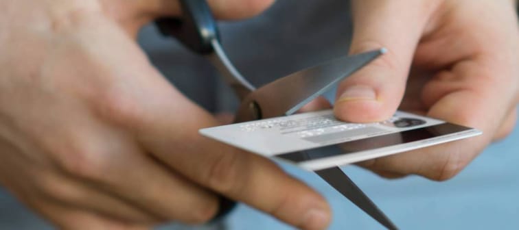 Using scissors to cut up a credit card