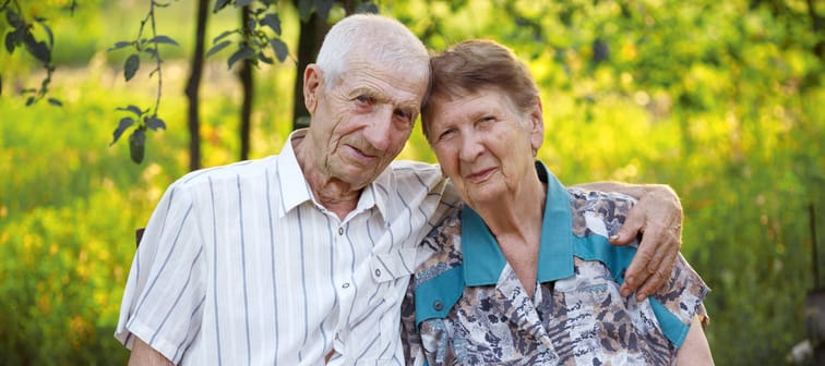 portrait of smiling senior man and senior woman at the garden