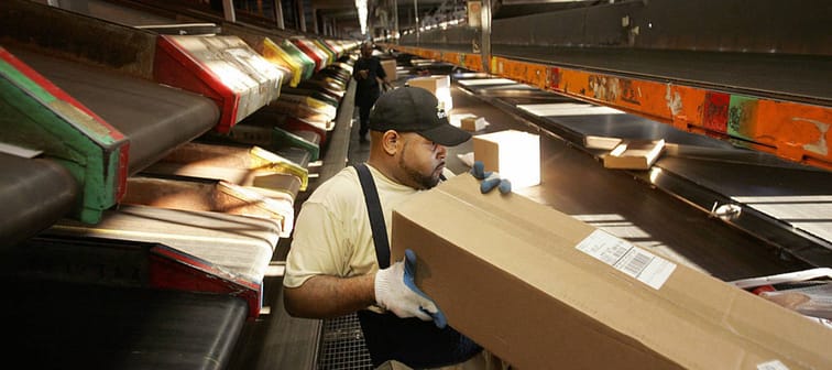 A man working in a UPS sorting facility.