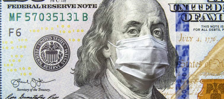 COVID-19 coronavirus in USA, 100 dollar money bill with face mask.
